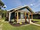 Inviting home with a welcoming porch and meticulously arranged flower beds at 1818 Broadway St, Anderson, IN 46012