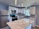 Contemporary kitchen equipped with stainless steel appliances, marble countertops, and a functional island at 1818 Broadway St, Anderson, IN 46012
