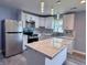 Modern kitchen features white cabinetry, stainless steel appliances, and a beautiful waterfall island at 1818 Broadway St, Anderson, IN 46012