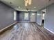Sun-filled living room with wood floors that flows seamlessly into the kitchen area at 1818 Broadway St, Anderson, IN 46012