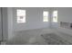 Sunlit bedroom with three windows and neutral walls, awaiting personal touches for comfort at 1890 Victor Higgins Dr, Shelbyville, IN 46176