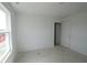 Bright bedroom featuring a window and a doorway, perfect for custom decor and comfortable living at 1890 Victor Higgins Dr, Shelbyville, IN 46176