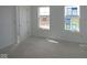 Bright bedroom featuring two windows offering natural light, complemented by a convenient interior door at 1890 Victor Higgins Dr, Shelbyville, IN 46176