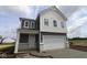 Inviting two-story home with a covered entry, gray siding, white trim, and a two-car garage at 1890 Victor Higgins Dr, Shelbyville, IN 46176
