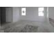 Spacious living room with neutral walls, two windows, and new construction, ready for personalization at 1890 Victor Higgins Dr, Shelbyville, IN 46176
