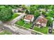 Aerial view of a home with mature trees, a detached garage and a driveway at 1904 N Bosart Ave, Indianapolis, IN 46218
