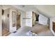 Unfinished attic features sloped ceilings, storage, and access to other rooms at 1904 N Bosart Ave, Indianapolis, IN 46218