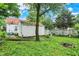 Spacious backyard with detached garage, bordered by a mix of wood and wire fencing at 1904 N Bosart Ave, Indianapolis, IN 46218
