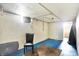 View of a white walled basement with blue floors, a chair and a carpet at 1904 N Bosart Ave, Indianapolis, IN 46218
