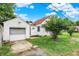 View of the side of a house with a garage with a closed door at 1904 N Bosart Ave, Indianapolis, IN 46218