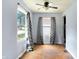 Bright living room with hardwood floors and windows dressed with patterned curtains at 1904 N Bosart Ave, Indianapolis, IN 46218