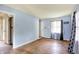 Spacious living room with hardwood floors, a front door, and ample natural light at 1904 N Bosart Ave, Indianapolis, IN 46218