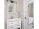 Bathroom with a white vanity, marble countertop and a framed mirror hanging above at 2018 N Rochester Ave, Indianapolis, IN 46222