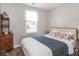 Cozy bedroom features a large window, hardwood floor and vintage-style furniture at 2018 N Rochester Ave, Indianapolis, IN 46222