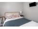 This is a cozy bedroom with TV and colorful decorative pillows on the bed at 2018 N Rochester Ave, Indianapolis, IN 46222