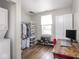 Walk-in closet is organized, with washer/dryer and a desk with monitor for convenience at 2018 N Rochester Ave, Indianapolis, IN 46222