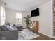 Comfortable living room featuring a gray couch, a sleek TV, and a wooden bookshelf at 2018 N Rochester Ave, Indianapolis, IN 46222