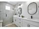 Elegant bathroom with double vanity, glass-enclosed shower, and modern fixtures at 205 Poplar St, Westfield, IN 46074