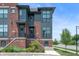 Modern townhome featuring brick and gray siding, enhanced by landscaped front entrances at 205 Poplar St, Westfield, IN 46074