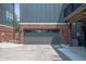 Close-up of a private garage entrance with a sleek gray door, brick accents, and a well-maintained driveway at 205 Poplar St, Westfield, IN 46074