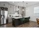 Modern kitchen with stainless steel appliances, gray cabinets, and a large island at 205 Poplar St, Westfield, IN 46074