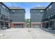 Rear exterior showcasing multiple townhome units, each with private garage entrances and parking areas at 205 Poplar St, Westfield, IN 46074