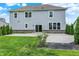 A home's backyard features a concrete patio, a large grassy area, and mature landscaping at 2074 Tompkins Dr, Westfield, IN 46074