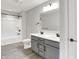 Modern bathroom features a double vanity, white countertops, and a separate bathtub and shower combination at 2074 Tompkins Dr, Westfield, IN 46074