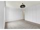 Empty bedroom with gray carpet, paneled walls, and a modern black light fixture at 2074 Tompkins Dr, Westfield, IN 46074