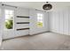 Bedroom with gray carpet, modern light fixture, three windows, and decorative shelves at 2074 Tompkins Dr, Westfield, IN 46074