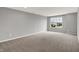 Bright bedroom featuring large windows offering natural light, complemented by soft carpeting and neutral walls at 2074 Tompkins Dr, Westfield, IN 46074