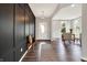Inviting foyer with dark accent wall, wooden floors, natural light, and a view of the dining area at 2074 Tompkins Dr, Westfield, IN 46074