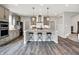 Kitchen features a large island, gray cabinets, stainless appliances, and wood flooring at 2074 Tompkins Dr, Westfield, IN 46074