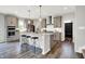 Kitchen features a large island, gray cabinets, stainless appliances, and barstool seating at 2074 Tompkins Dr, Westfield, IN 46074
