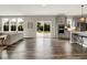Large, open living area with kitchen, sliding glass doors, and dark wood floors at 2074 Tompkins Dr, Westfield, IN 46074