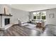 Comfortable living room with a stone fireplace, a large sofa, and abundant natural light at 2074 Tompkins Dr, Westfield, IN 46074