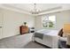 Main bedroom features neutral decor, tray ceiling with chandelier, plush carpet, and a sunny window at 2074 Tompkins Dr, Westfield, IN 46074