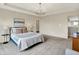 Main bedroom showcasing a tray ceiling, chandelier, plush carpeting, and neutral decor for a relaxing retreat at 2074 Tompkins Dr, Westfield, IN 46074