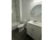 Clean bathroom featuring modern vanity and shower-over-tub with marble tile at 2127 Haines Ave, Indianapolis, IN 46221