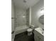 Clean bathroom featuring modern vanity and shower-over-tub with marble tile at 2127 Haines Ave, Indianapolis, IN 46221