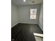 Empty bedroom featuring one window, painted walls, and luxury vinyl plank flooring at 2127 Haines Ave, Indianapolis, IN 46221