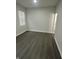 Bright, airy room featuring modern window, hardwood floors, and crisp white walls at 2127 Haines Ave, Indianapolis, IN 46221