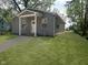 Beautiful home exterior featuring gray siding, a covered porch, and lush green lawn at 2127 Haines Ave, Indianapolis, IN 46221