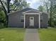 Charming gray home featuring a cozy front porch, white trim, and a freshly mowed lawn at 2127 Haines Ave, Indianapolis, IN 46221