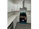 A contemporary kitchen with stainless steel appliances, a new stove and sleek white cabinetry at 2127 Haines Ave, Indianapolis, IN 46221