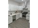 Bright kitchen featuring stainless steel appliances, white cabinets, stone countertops and tiled backsplash at 2127 Haines Ave, Indianapolis, IN 46221