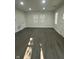 Spacious living area featuring sleek gray floors and large windows that fill the room with natural light at 2127 Haines Ave, Indianapolis, IN 46221