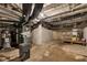 Unfinished basement with concrete floor, exposed pipes, and utility equipment visible at 247 N 14Th St, Noblesville, IN 46060