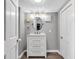 Bathroom with white vanity, a round mirror, and modern fixtures at 247 N 14Th St, Noblesville, IN 46060