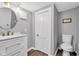 A functional bathroom with modern fixtures, a round mirror and a toilet at 247 N 14Th St, Noblesville, IN 46060